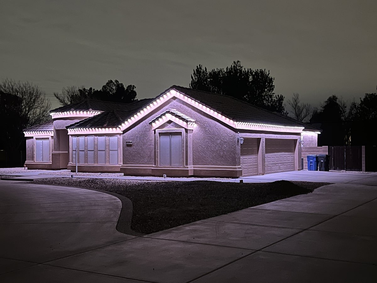 Single-story home with crisp white permanent roofline lighting